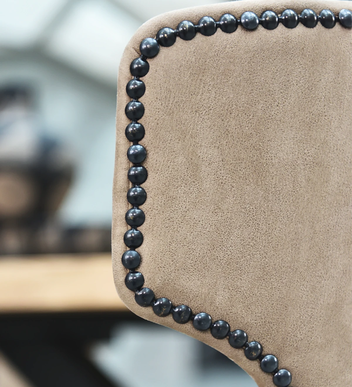 Fabric upholstered chair, with black tack on the back and black lacquered feet.