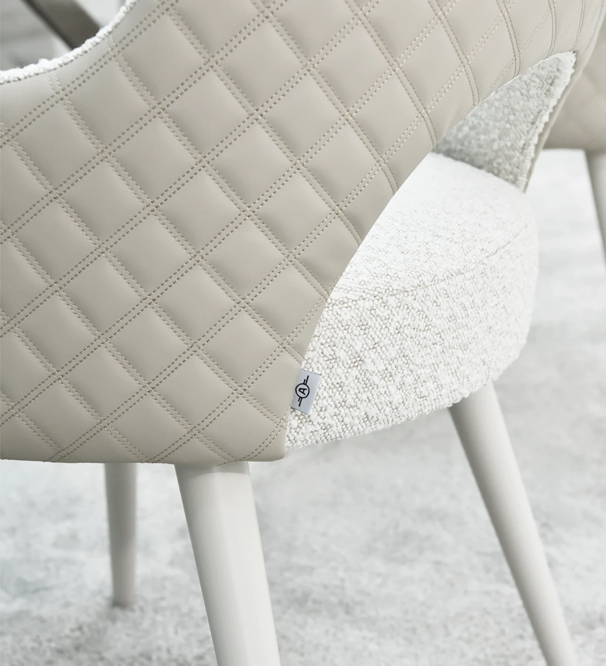 Chair with arms, upholstered in fabric, pearl lacquered feet.