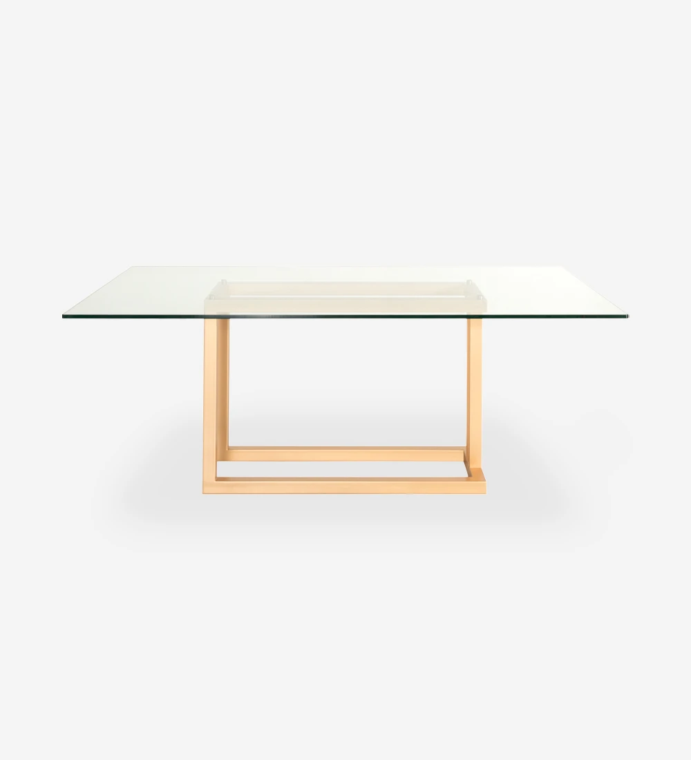 Rectangular dining table with glass top and gold lacquered metal foot.