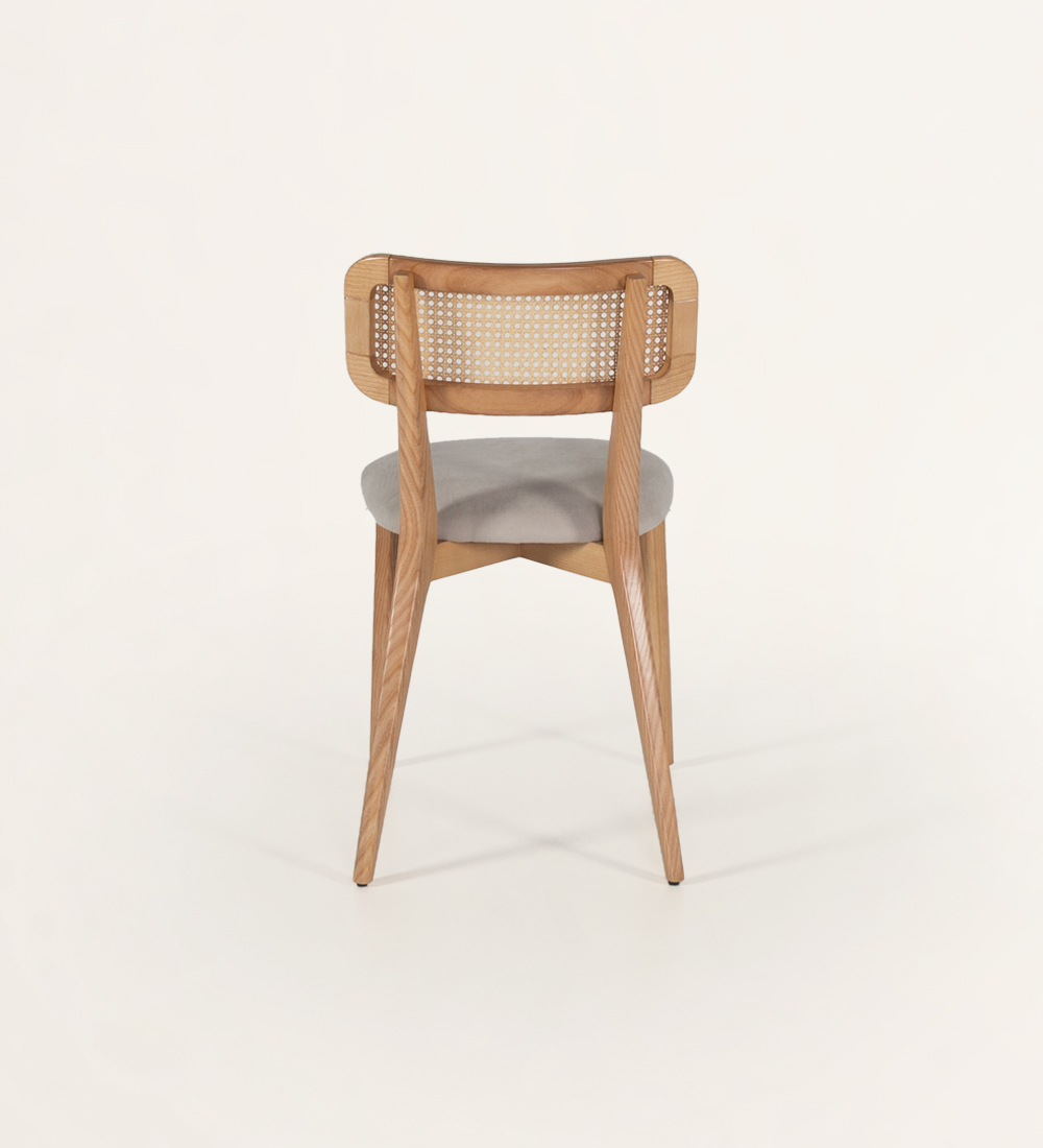 Wood chair, with rattan detail on the back and fabric upholstered seat.