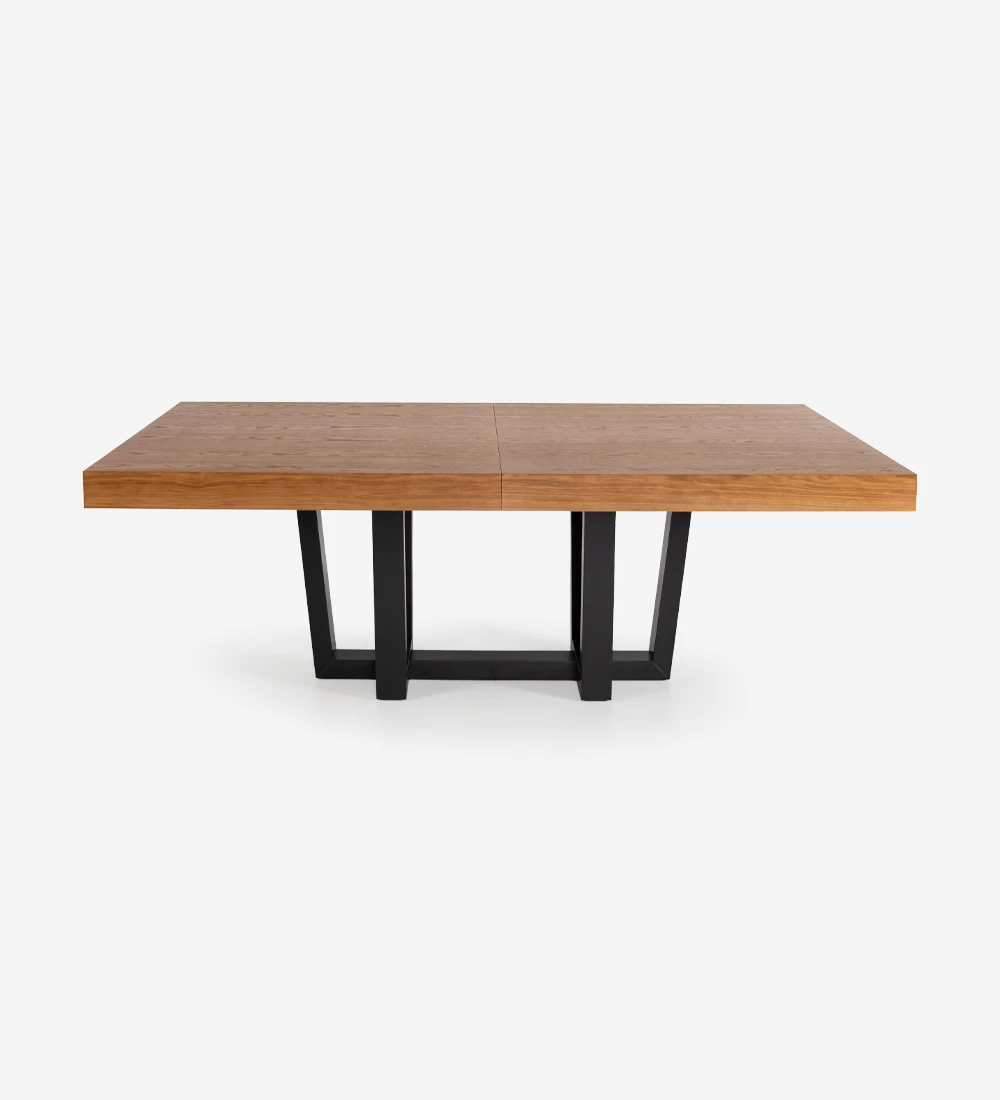 Rectangular extendable dining table with honey oak top and black lacquered foot.