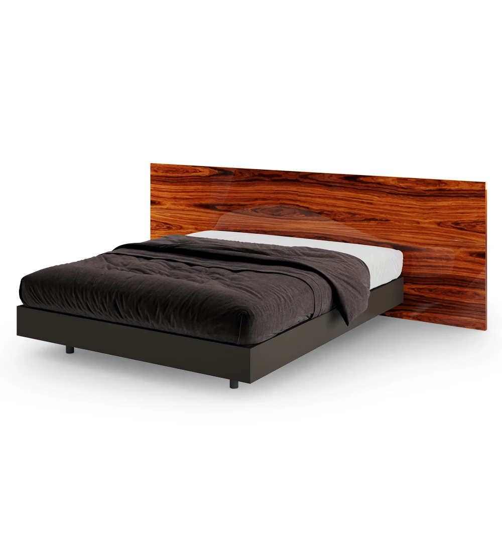Double bed with headboard in high gloss palissander and suspended base in black.