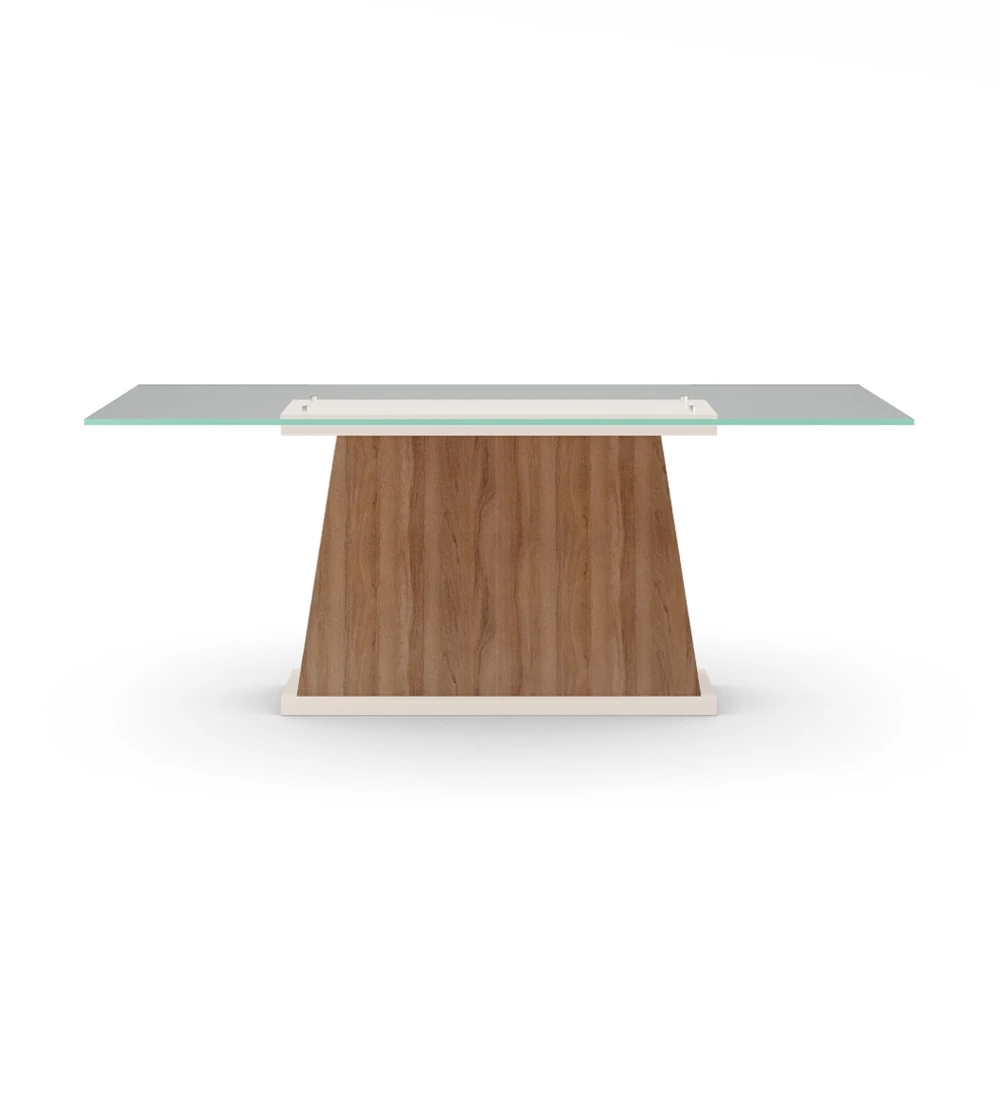 Mesa de comedor rectangular con tablero de cristal, pie central de nogal y base lacada perla.