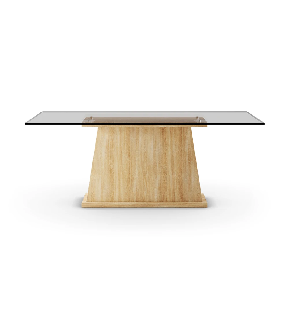 Mesa de comedor rectangular con tapa de cristal y pie central en roble de color natural.