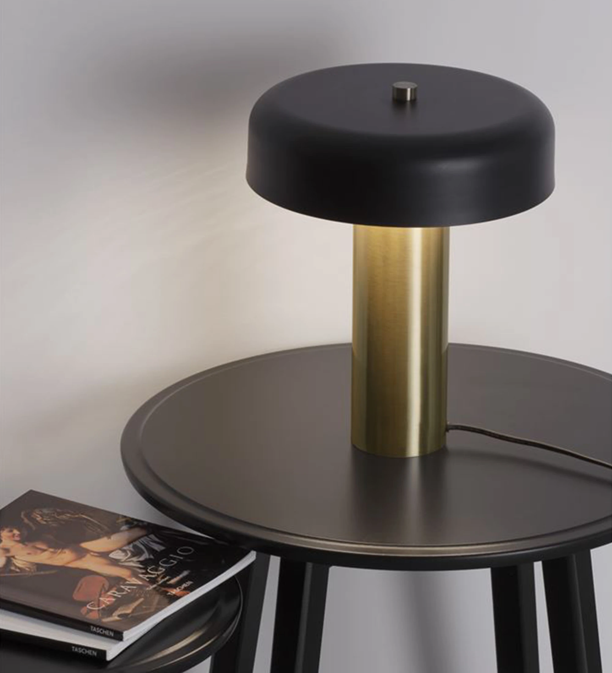 Table lamp in gold aluminum and shade in black aluminum.