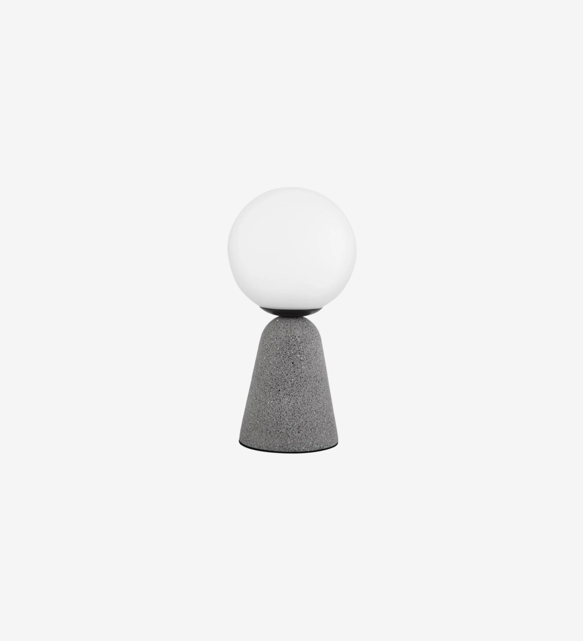 Lampe de table avec base en béton gris et diffuseur en verre opale.