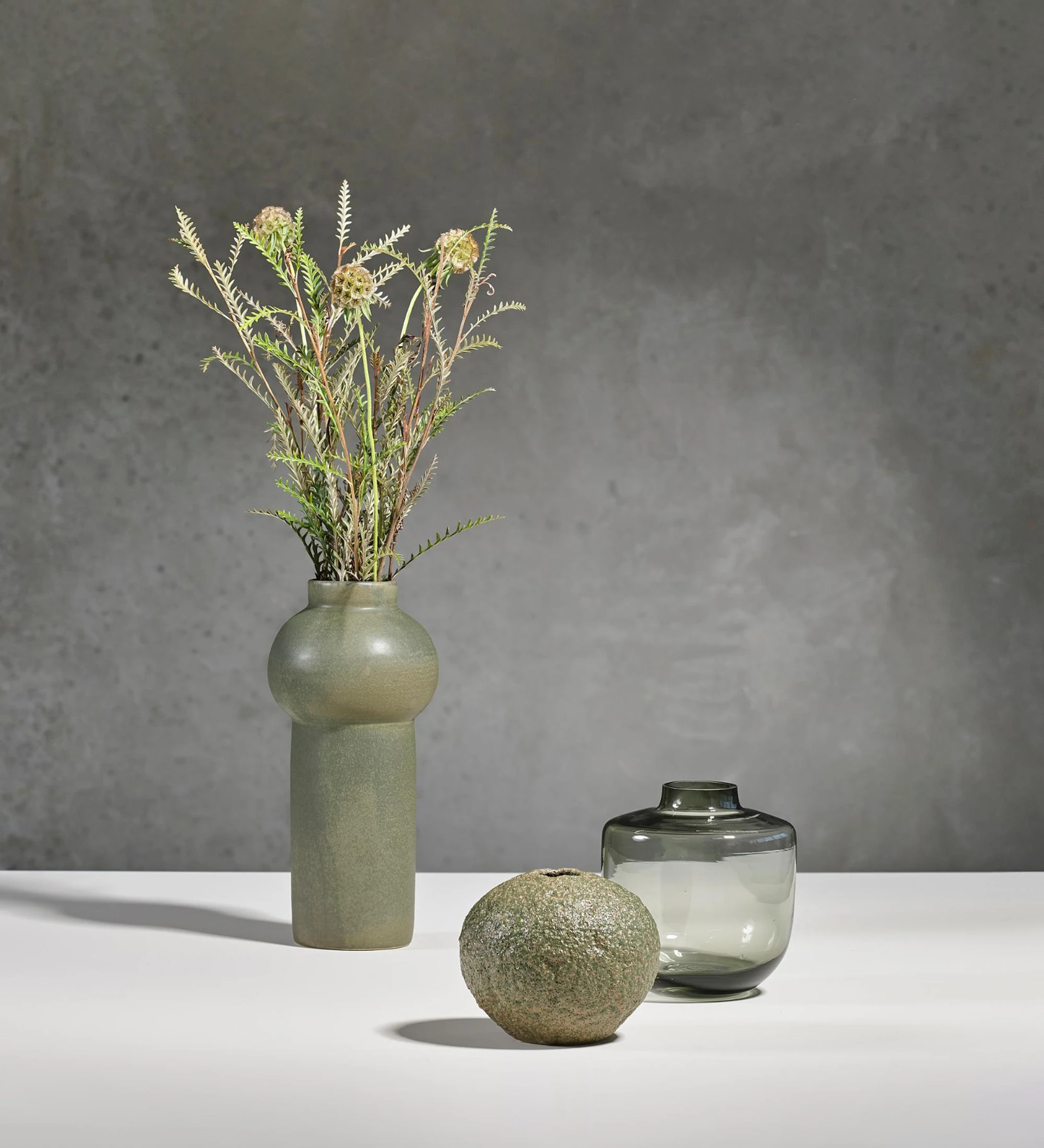 Handmade green stoneware vase with relative glaze.