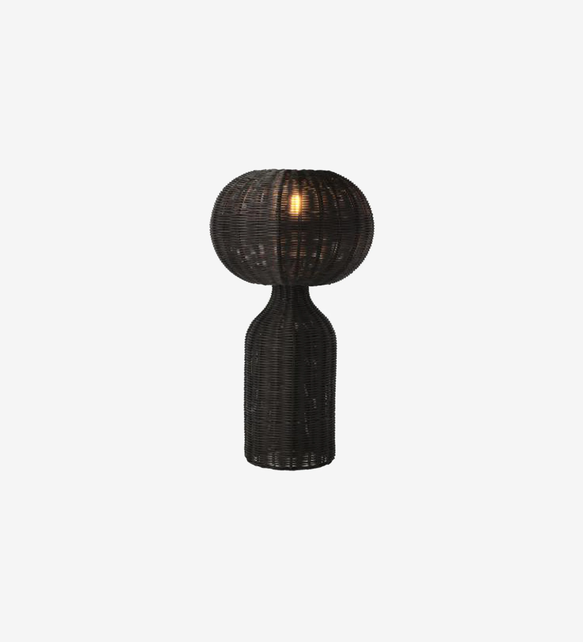 Black rattan table lamp with gentle, elegant light.