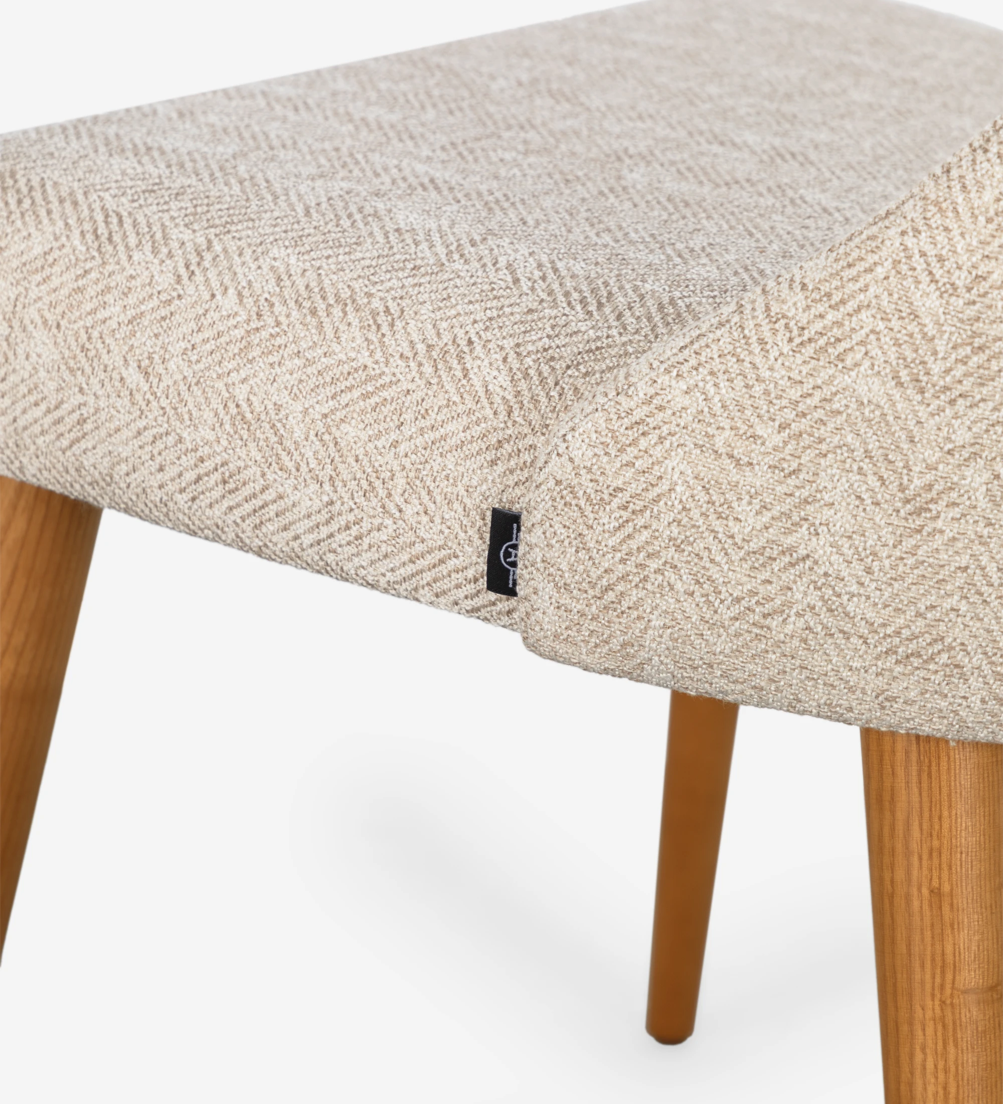 Silla Oslo tapizada en tela beige y patas de madera color miel.