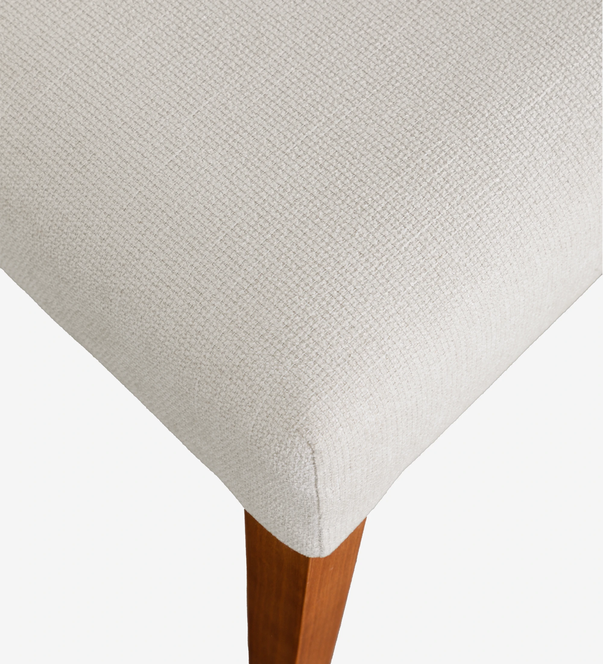 Chair upholstered in beige fabric, with honey-colored wooden legs.