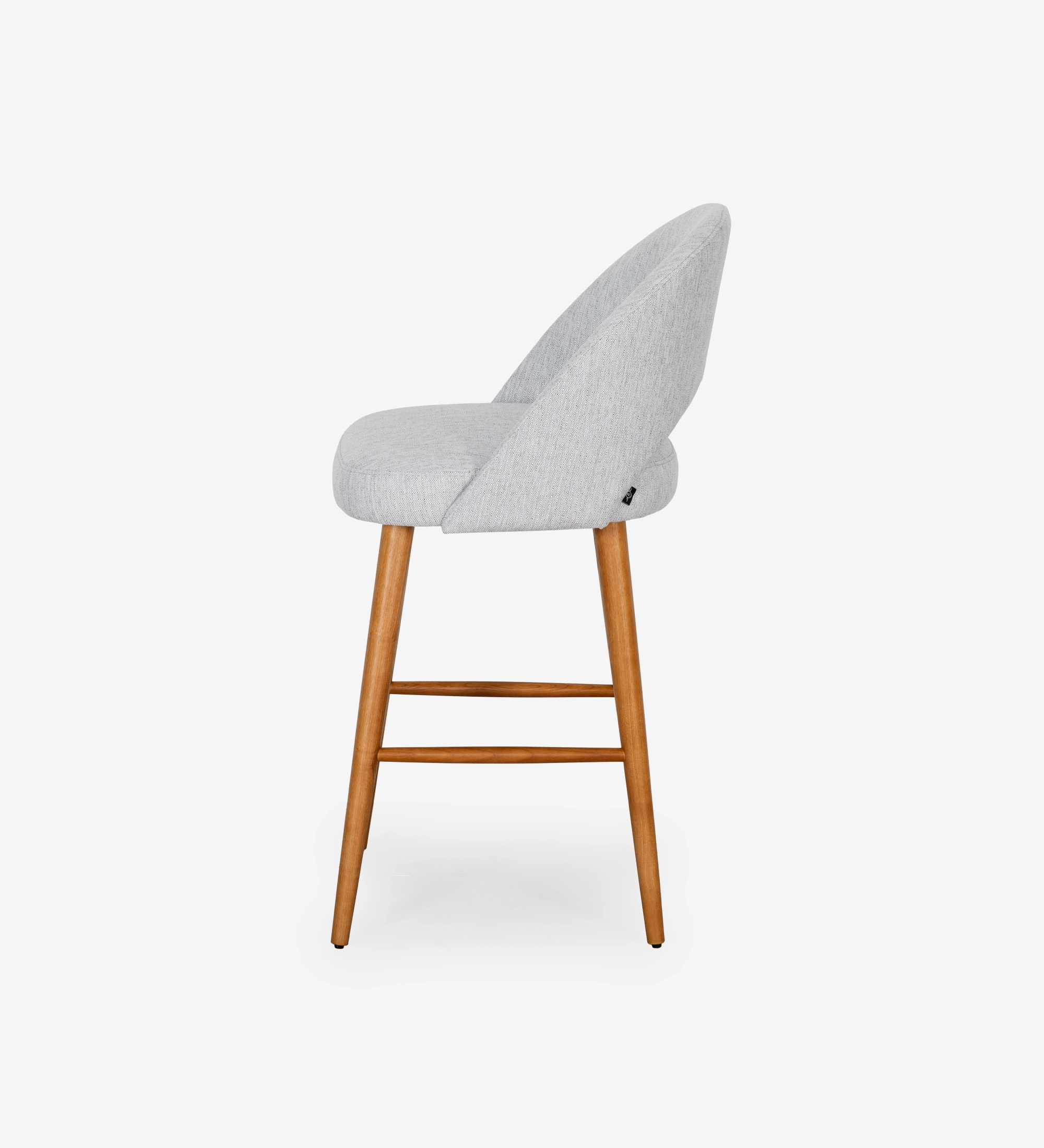 Stool with light grey fabric upholstered, with honey-colored wooden feet.