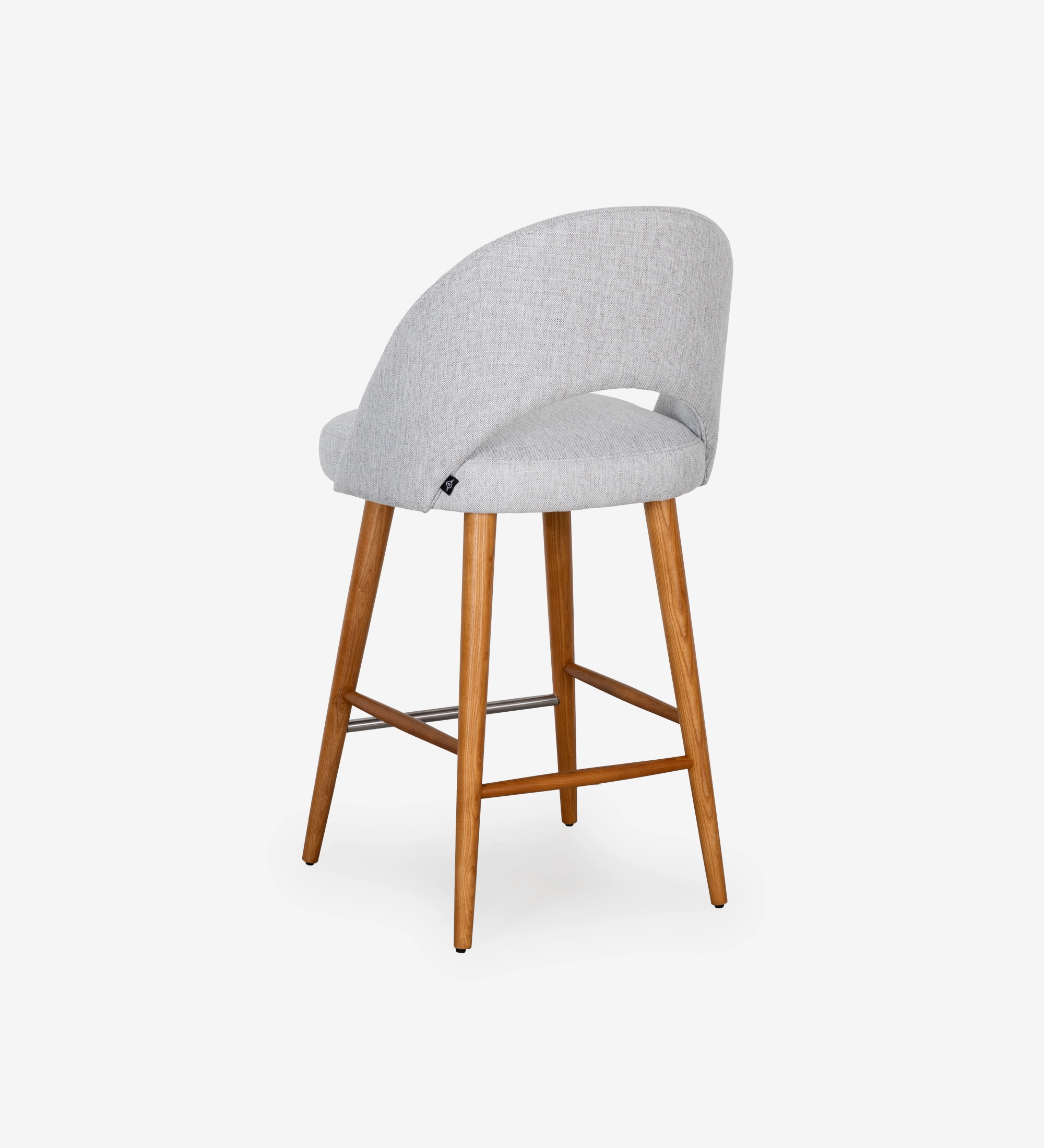 Stool with light grey fabric upholstered, with honey-colored wooden feet.