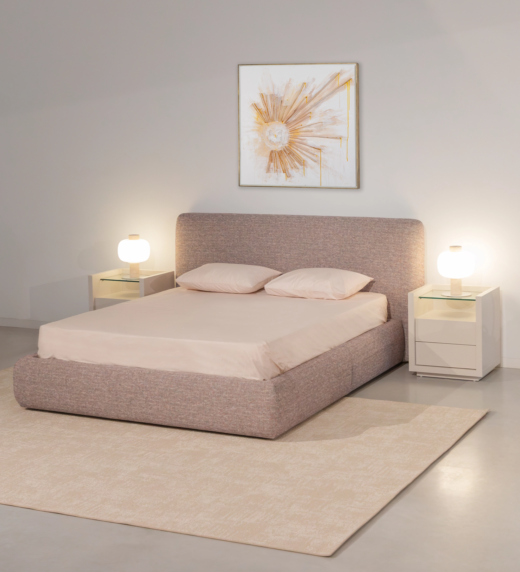 Double bed with short headboard, upholstered in multicolored fabric, primarily red and blue.