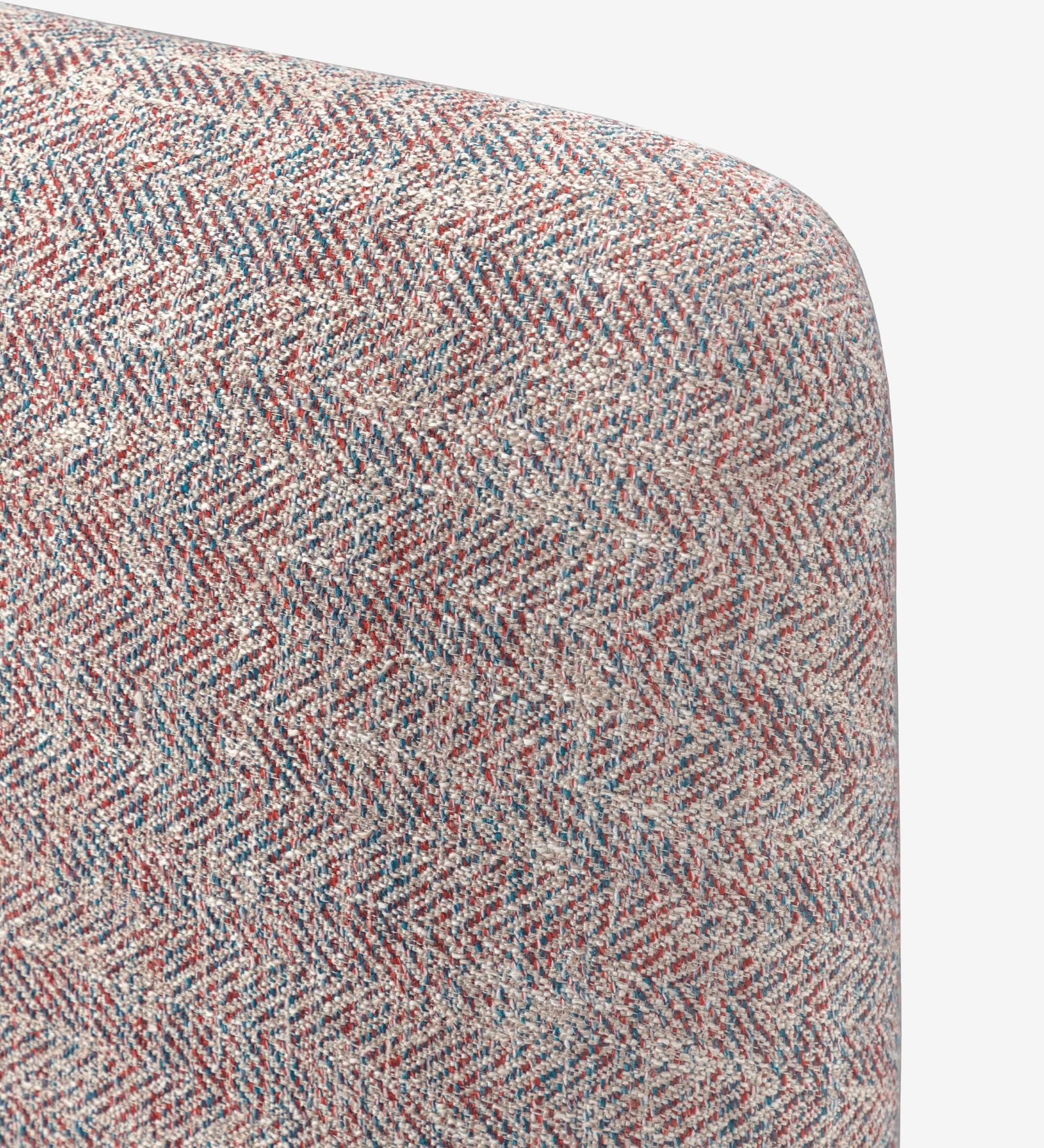 Double bed with short headboard, upholstered in multicolored fabric, primarily red and blue.