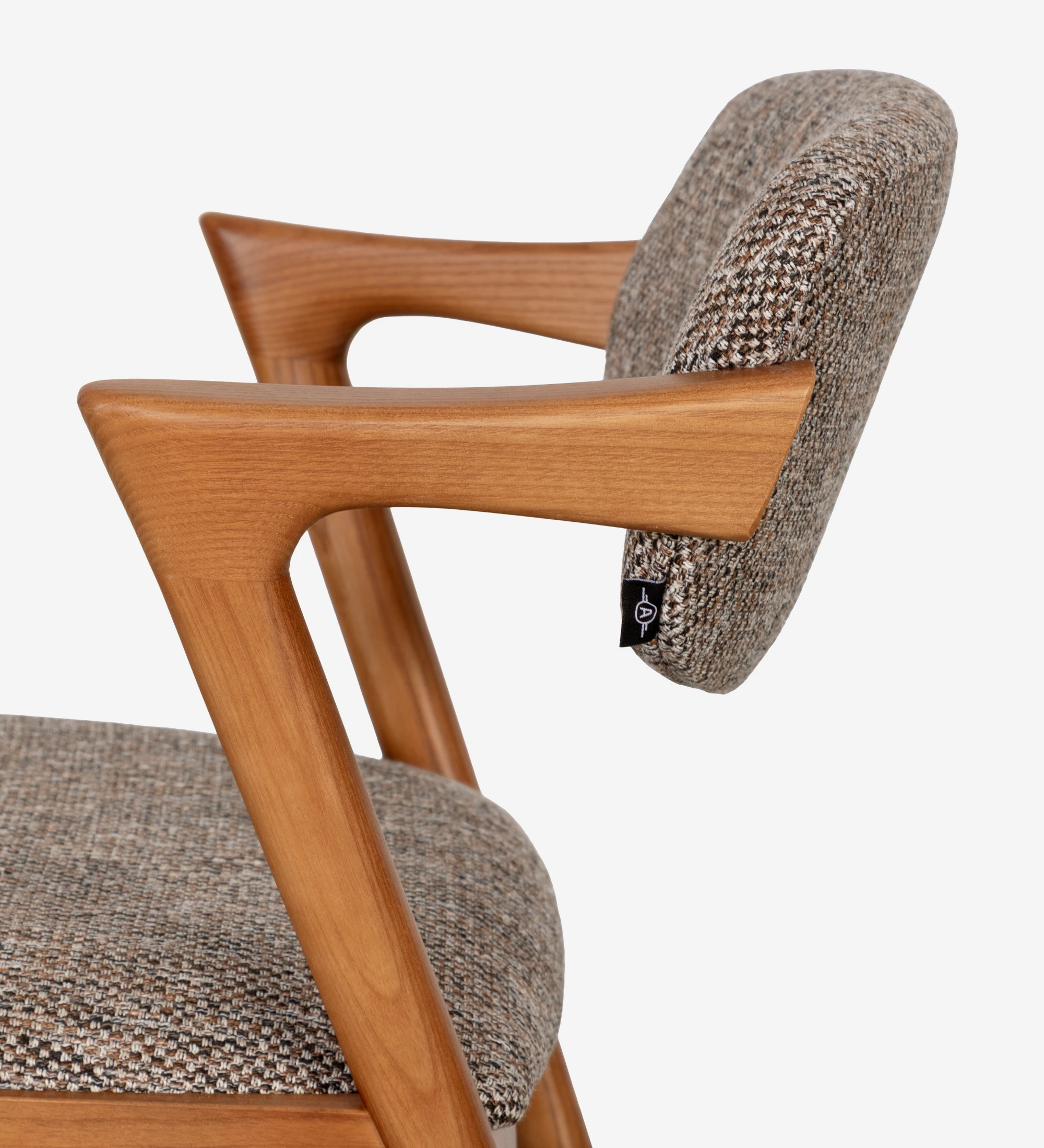 Chaise en frêne couleur miel, avec assise et dossier rembourrés en tissu multicolore, principalement dans les tons bruns et beige.