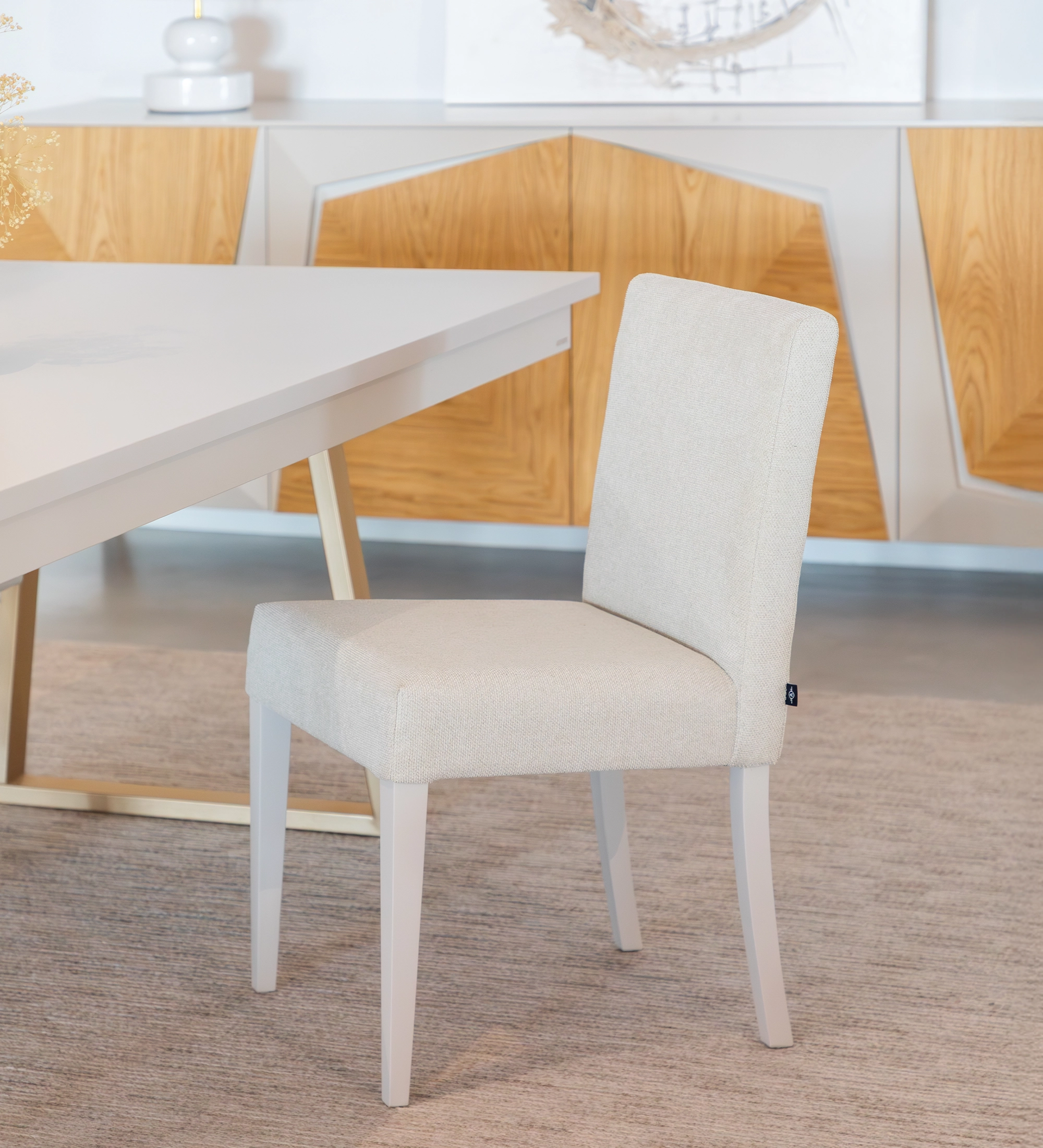 Chair upholstered in fabric, pearl lacquered feet.