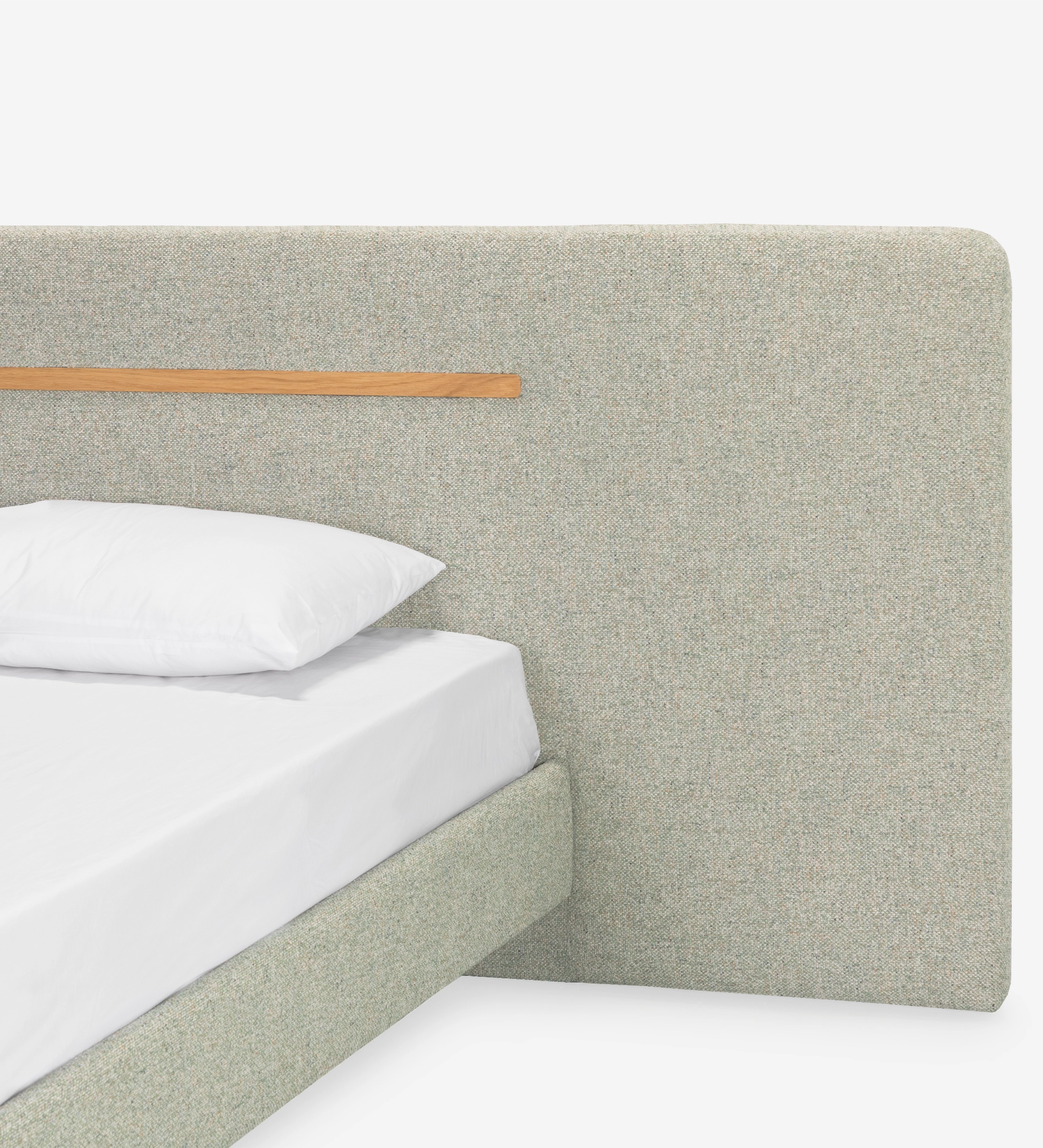 Double bed with upholstered headboard and floating base in green fabric, detail in natural oak.