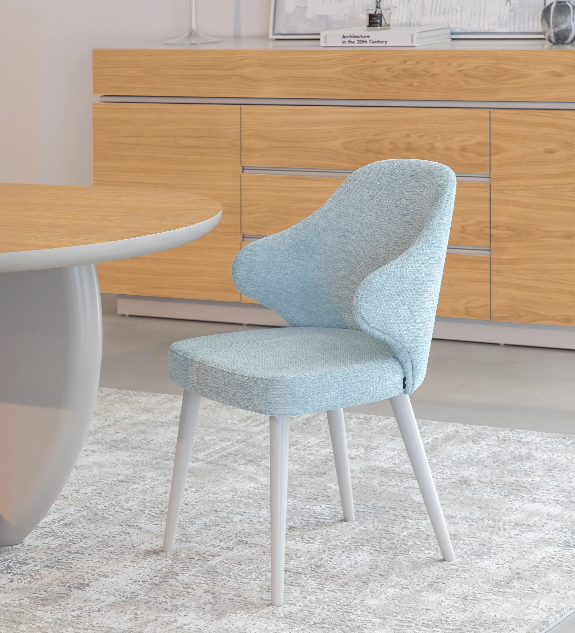Chair upholstered in blue fabric, feet lacquered in pearl.