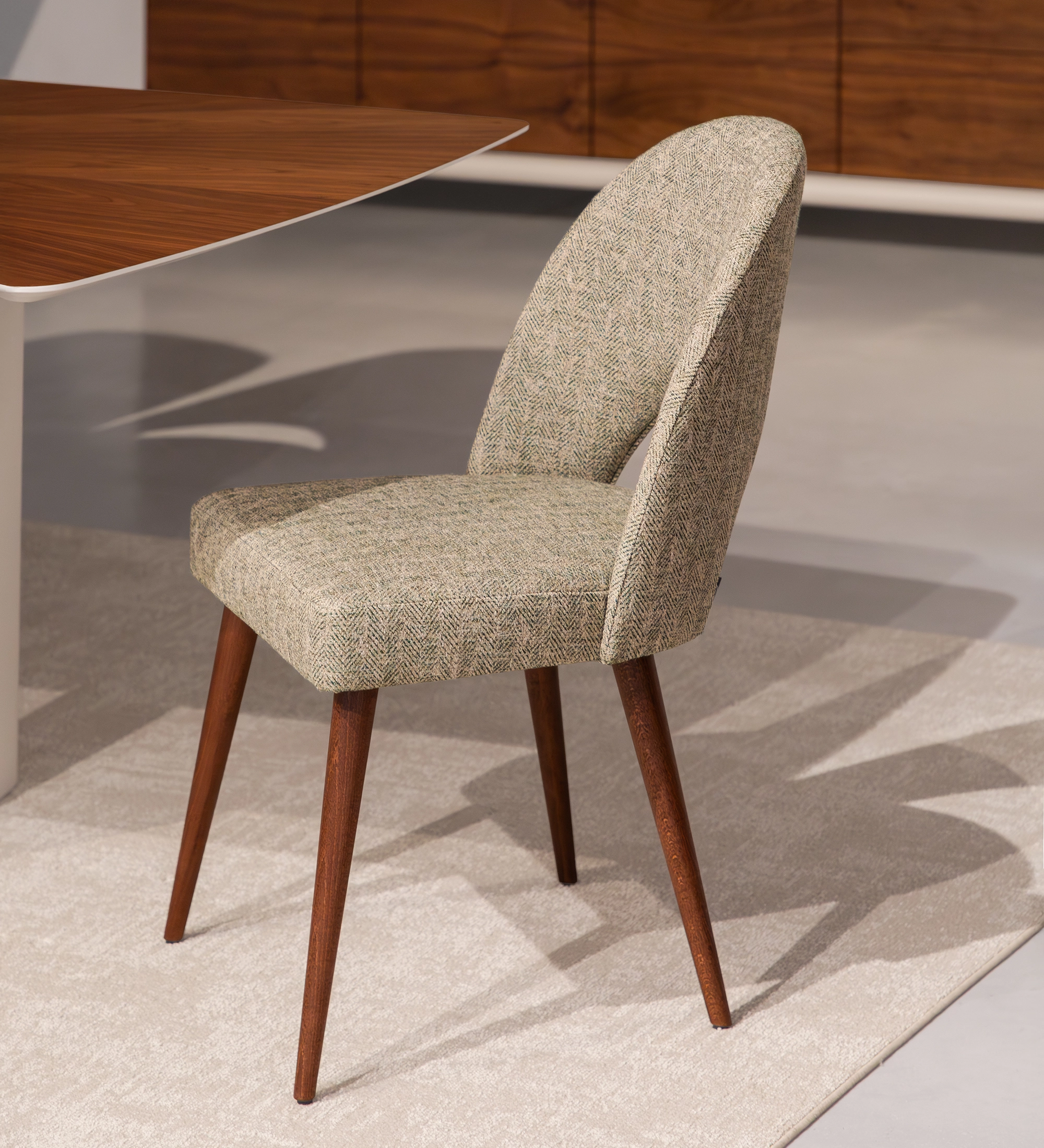 Paris Chair upholstered in neutral herringbone fabric with tapered wooden legs