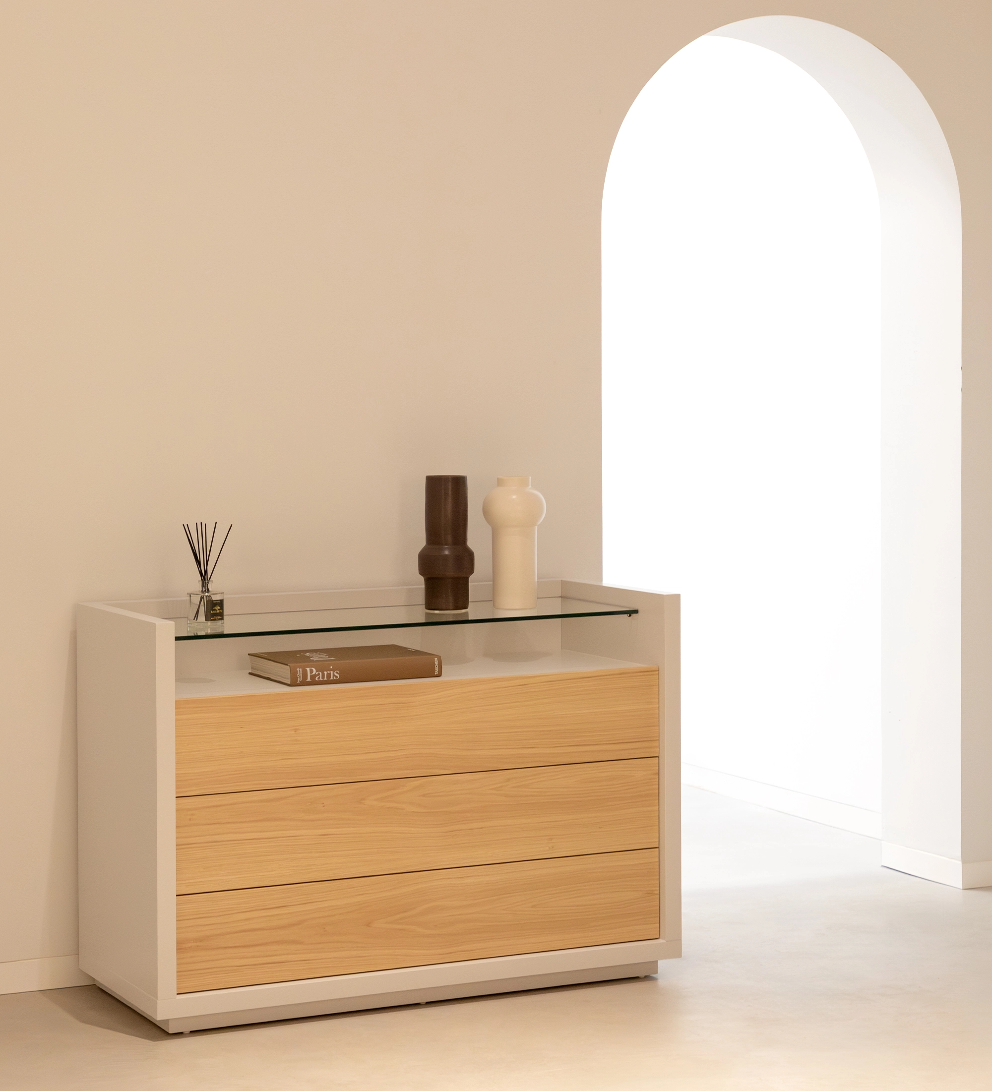 Commode Londres blanche et bois clair à trois tiroirs, plateau en verre et vases décoratifs