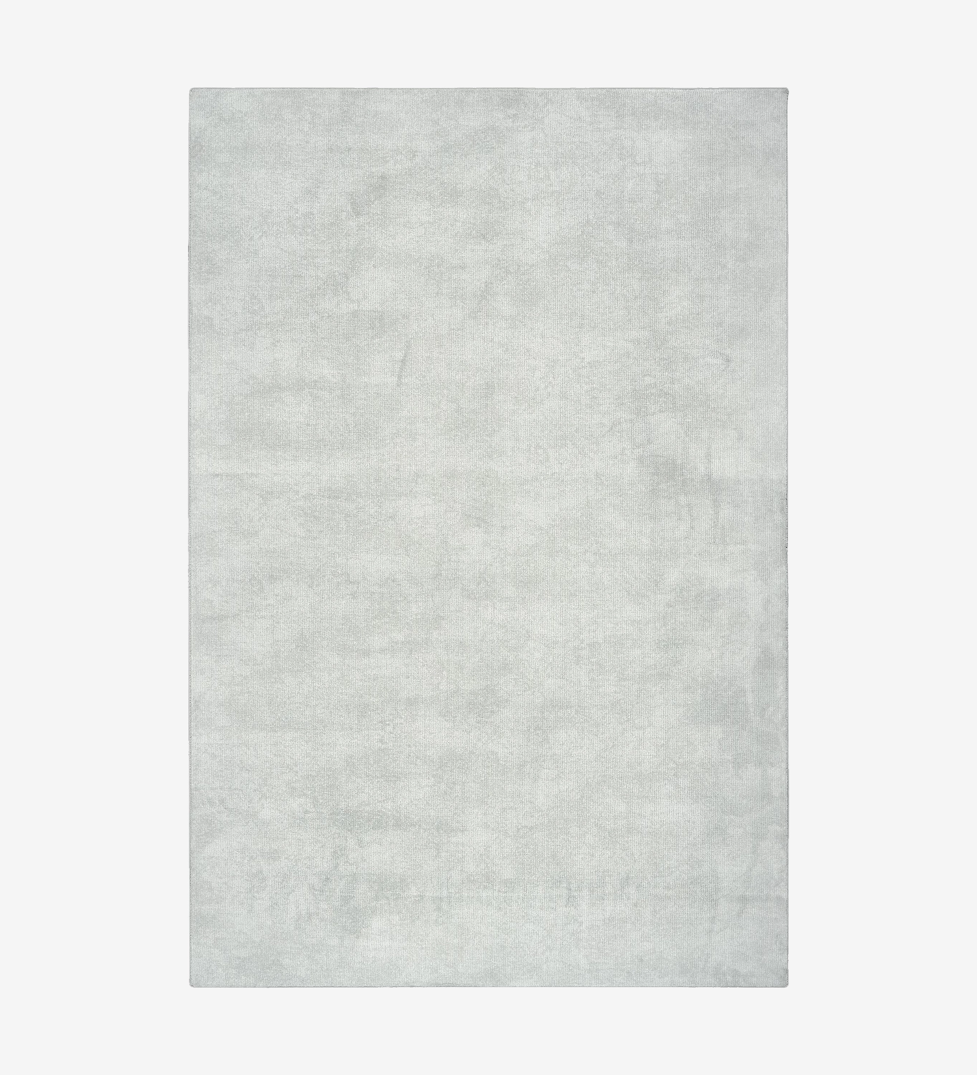 Alfombra con un patrón en tonos gris, acabado con borde doblado + feltex de 6 mm.