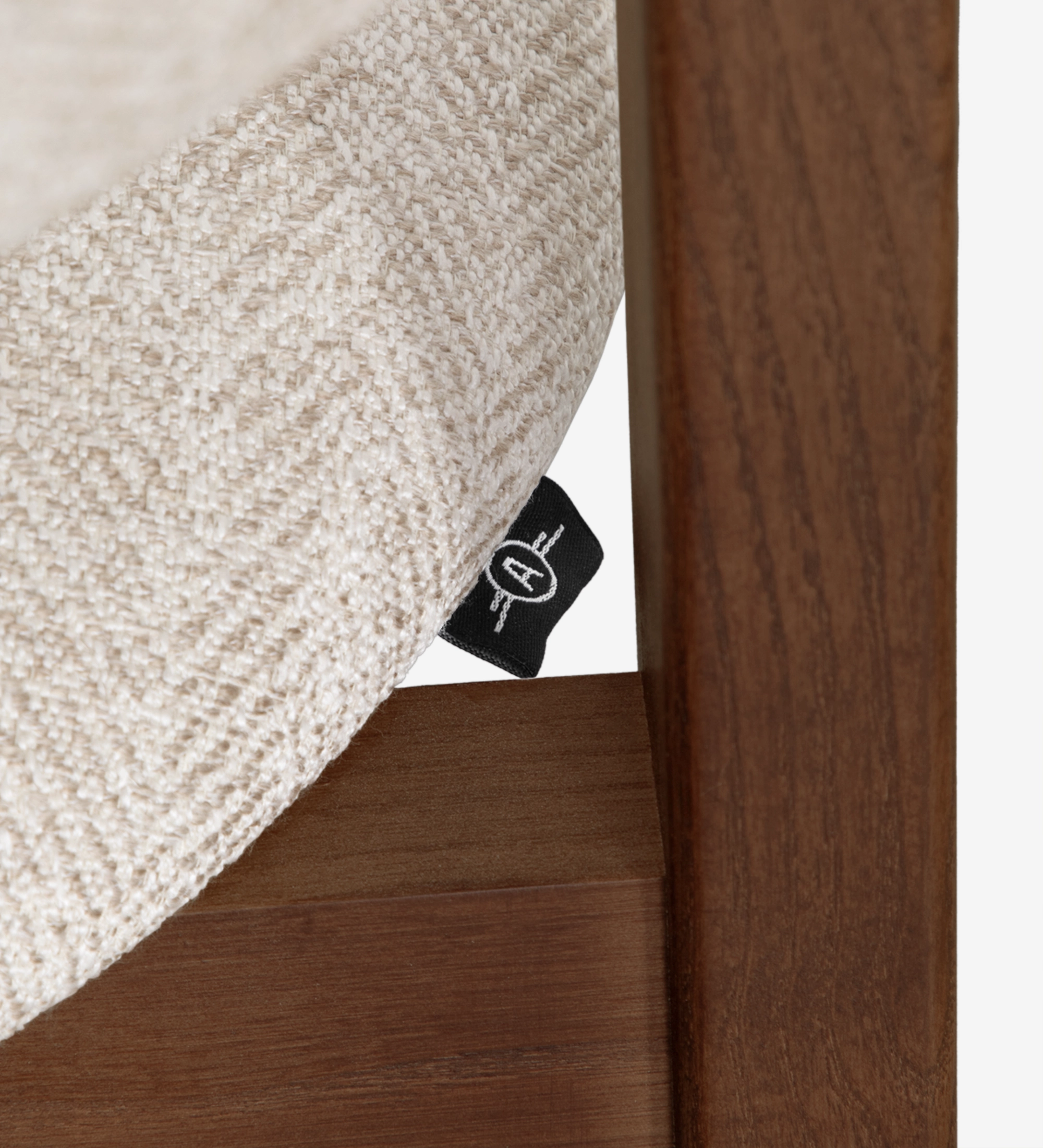 Chair with arms, in walnut-colored ash wood, with seat and back upholstered in beige fabric.