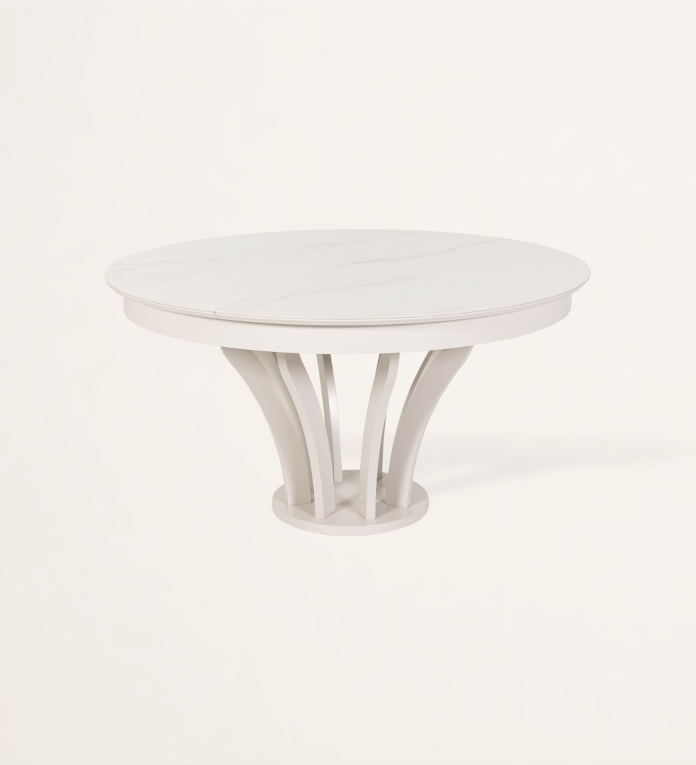 Mesa de comedor redonda extensible con tablero de cerámica y pie lacado perla.