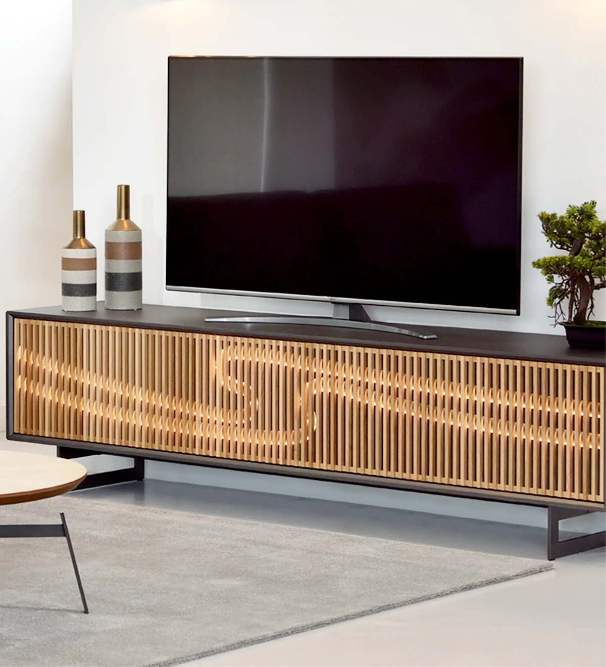 Mueble TV con 2 puertas plegables en roble natural, marco y pies metálicos lacados en negro metalizado.