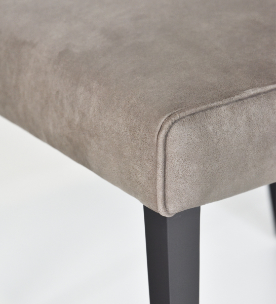 Upholstered in fabric, black lacquered feet.