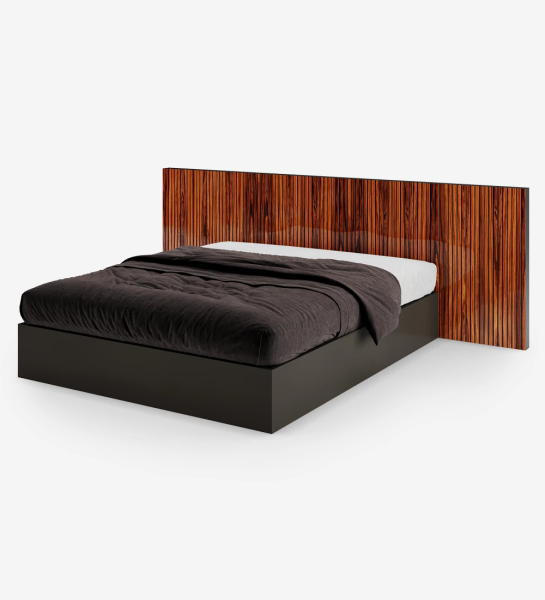 Double bed with high gloss palisander headboard with friezes and black lacquered base, with storage through a lifting platform.