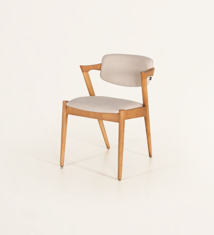 Chair in honey-colored ash wood, with seat and back upholstered in fabric.