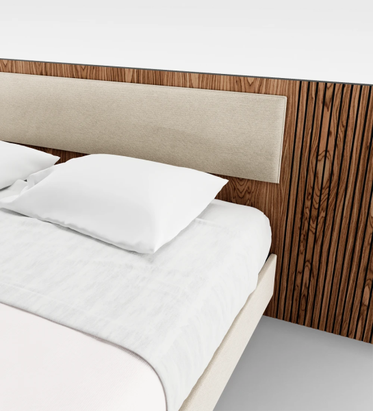 Double bed with upholstered headboard center panel, headboard sides with walnut trim, and upholstered hanging base.
