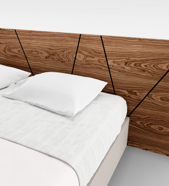 Double bed with abstract walnut headboard and pearl base, with storage through a lifting platform.
