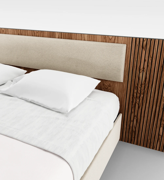 Double bed with upholstered central headboard panel, walnut headboard sides with friezes and upholstered base, with storage through a lifting platform.