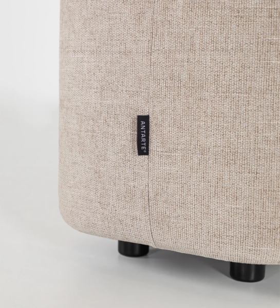 Fabric upholstered stool, black feet.