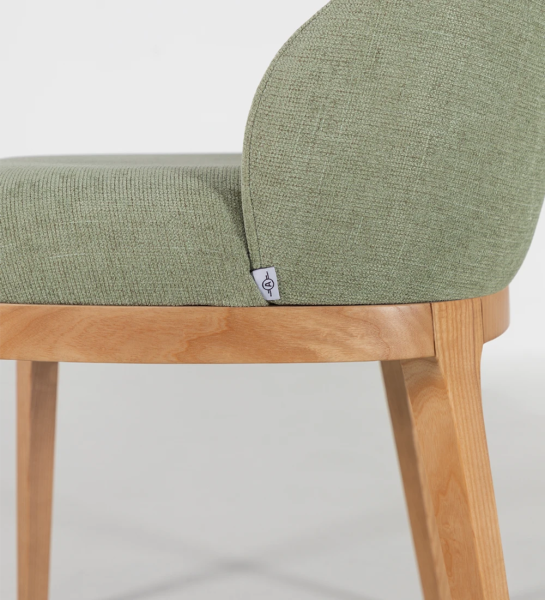 Chair upholstered in fabric, with wooden feet.