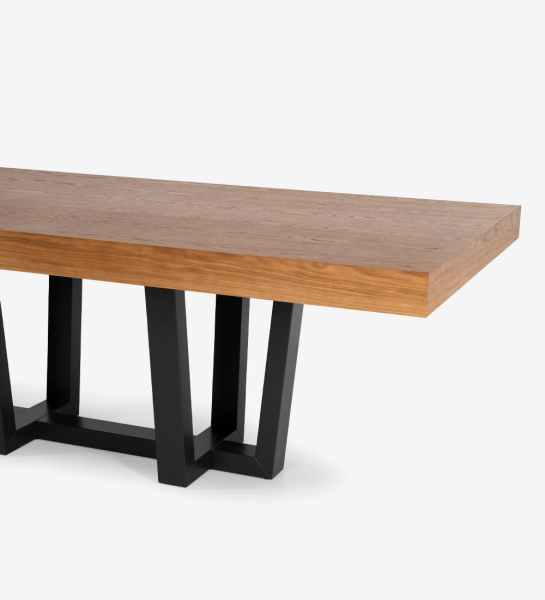 Rectangular extendable dining table with honey oak top and black lacquered foot.