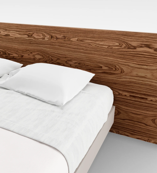 Double bed with walnut headboard and suspended base in pearl.