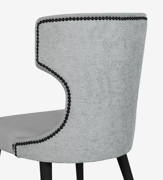 Fabric upholstered chair, with black tack on the back and anthracite lacquered feet.