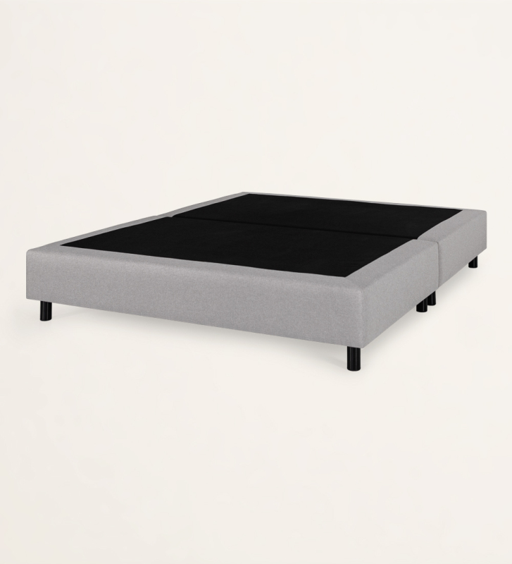 Simple double sommier, divided horizontally, upholstered in fabric.