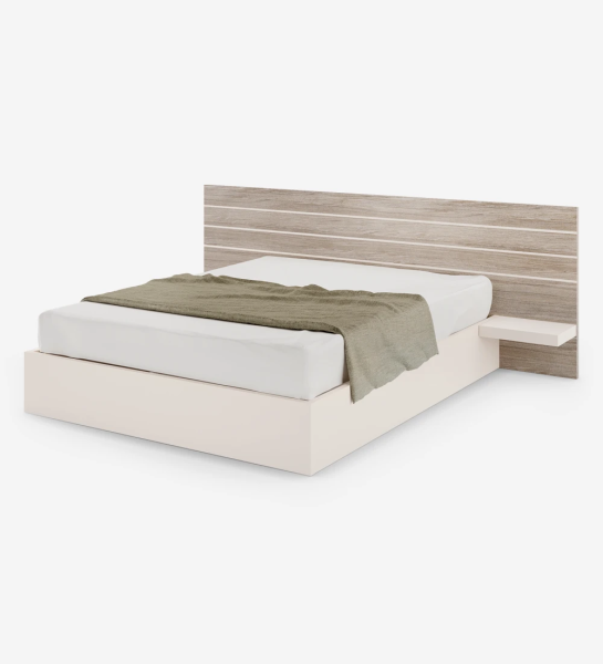 Lit double avec tête de lit en chêne decapé, avec étagères et base en perle, avec rangement via un lit surélevé.