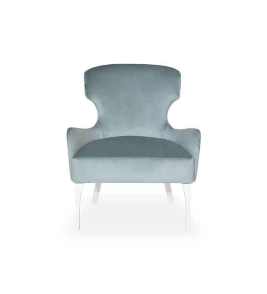 Pico armchair upholstered in sapphire fabric, silver studs, pearl lacquered feet.