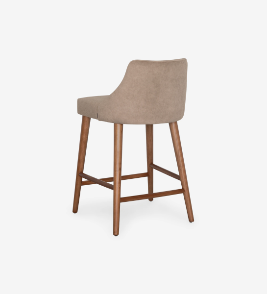 Oslo high stool upholstered in fabric, legs in walnut wood.