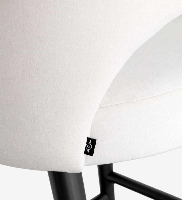 Stool with fabric upholstered arms, with black lacquered feet.