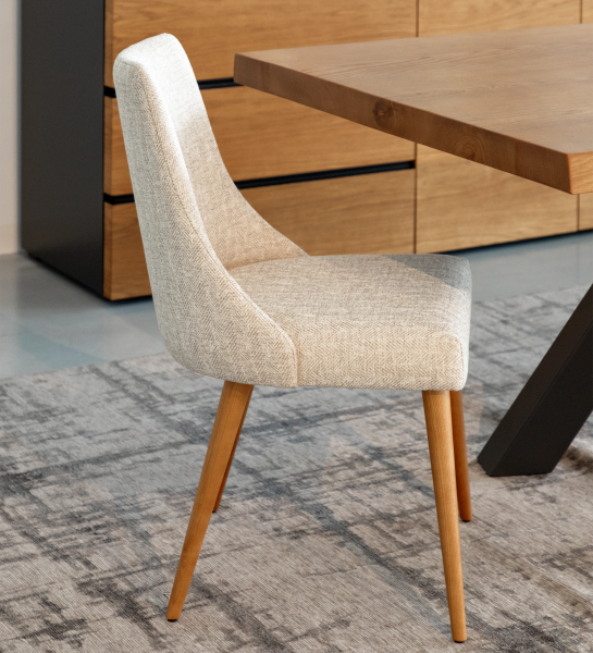 Oslo chair upholstered in beige fabric and honey-colored wooden legs.