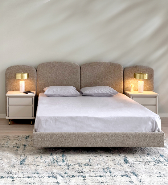 Double bed with upholstered in light gray headboard and suspended base.