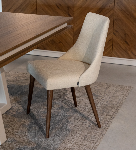 Oslo chair upholstered in beige fabric and and walnut wood legs.