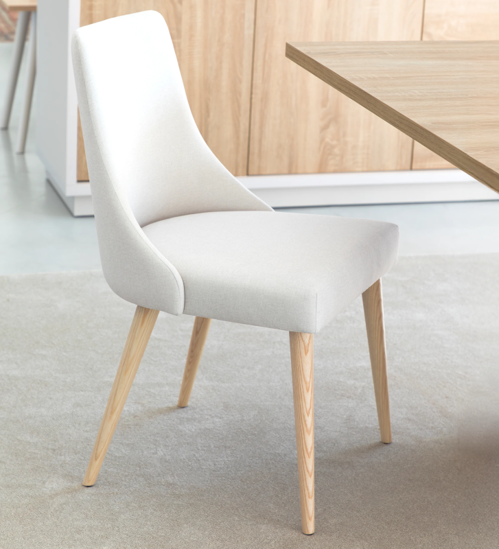 Oslo chair upholstered in white fabric and natural colored wooden legs.