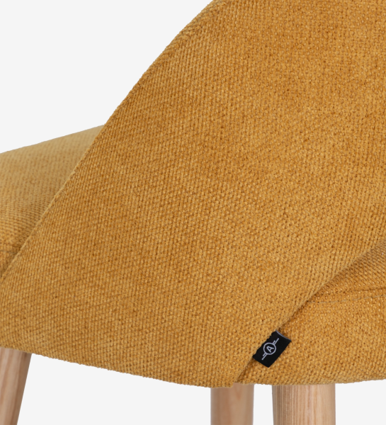 Stool upholstered in yellow fabric, with natural colored wooden legs.