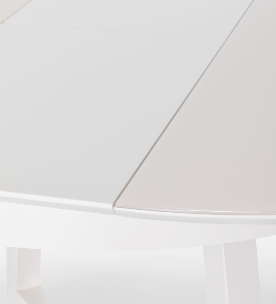 Round extendable dining table in pearl lacquer with glass top and pearl lacquer extension.